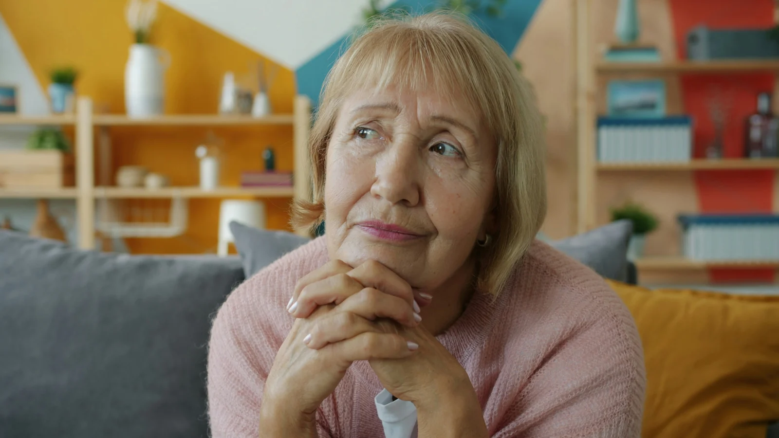 A woman thinking something over at home